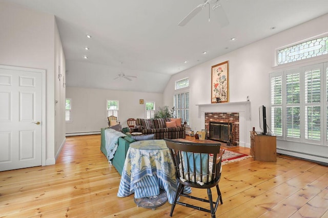 181 Pleasant St, South Yarmouth, MA 02664 - living room with ceiling fan, light wood finished floors, a fireplace, baseboard heating, and vaulted ceiling
