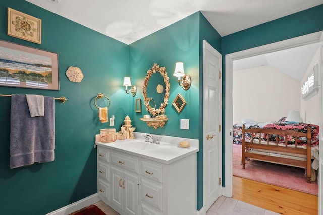 181 Pleasant St, South Yarmouth, MA 02664 - bathroom featuring vanity, baseboards, and lofted ceiling