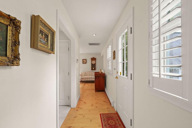 181 Pleasant St, South Yarmouth, MA 02664 - hall with light wood-style floors, a baseboard heating unit, and baseboards