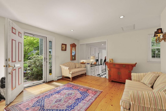 181 Pleasant St, South Yarmouth, MA 02664 - living room featuring a baseboard radiator, light wood-type flooring, and recessed lighting