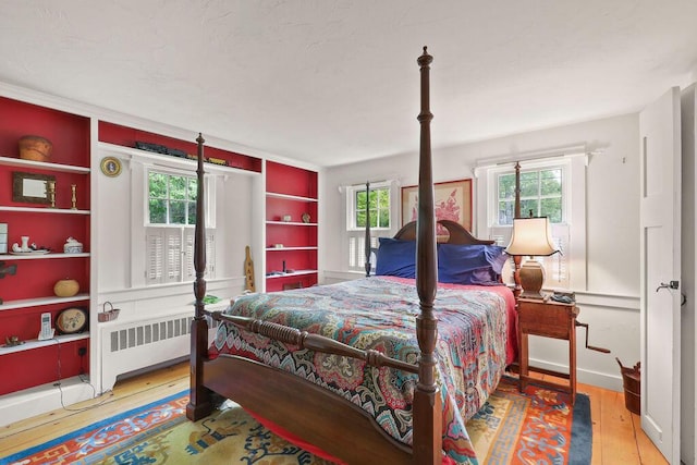 181 Pleasant St, South Yarmouth, MA 02664 - bedroom featuring radiator, multiple windows, and hardwood / wood-style floors