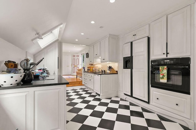 181 Pleasant St, South Yarmouth, MA 02664 - kitchen featuring oven, paneled built in refrigerator, a skylight, light flooring, and dark countertops
