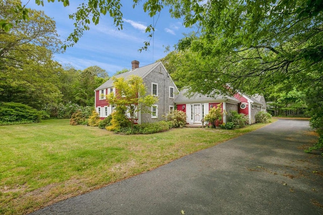 181 Pleasant St, South Yarmouth, MA 02664 - view of front facade with asphalt driveway, a front yard, and a chimney