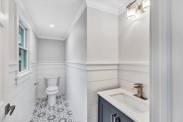 bathroom featuring vanity, crown molding, and toilet