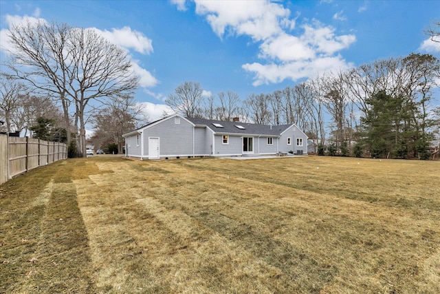 back of house with a lawn