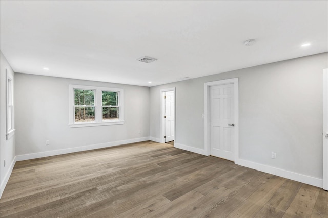 unfurnished room with hardwood / wood-style flooring