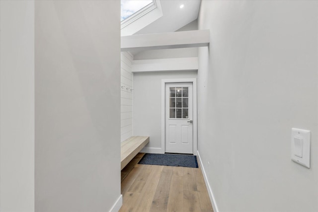 mudroom featuring hardwood / wood-style flooring and vaulted ceiling