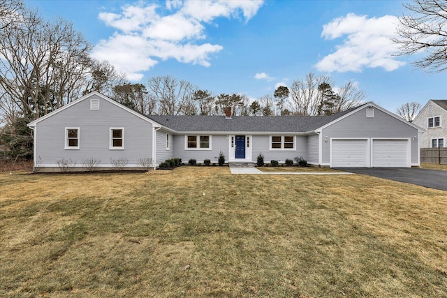 single story home featuring a garage and a front lawn