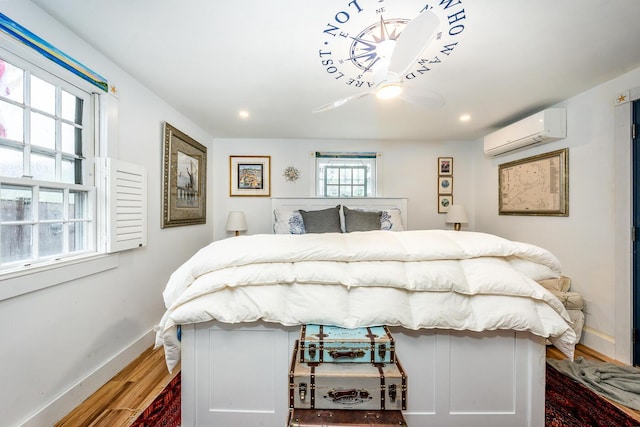 21 Nickerson Rd Unit 3, Cotuit, MA 02635 - bedroom with an AC wall unit, multiple windows, wood finished floors, and recessed lighting