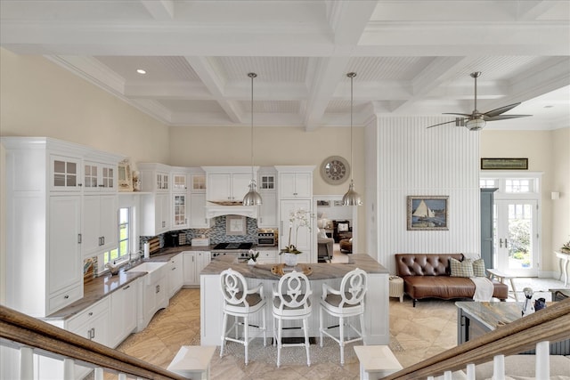 16 Beach View Rd, West Dennis, MA 02670 - kitchen with stove, coffered ceiling, beam ceiling, a kitchen island, and a high ceiling