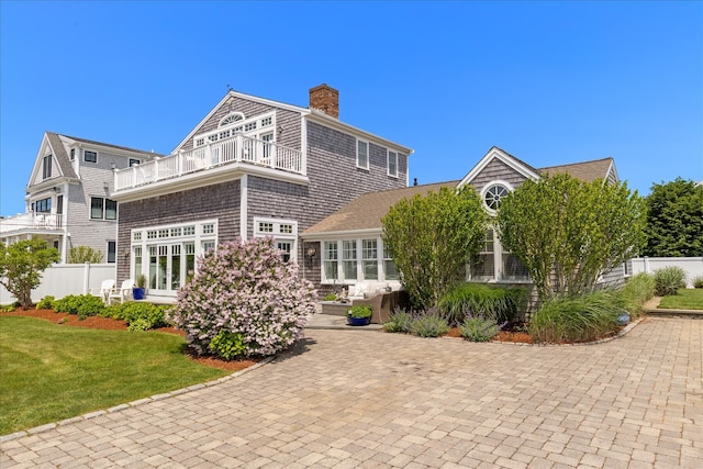 16 Beach View Rd, West Dennis, MA 02670 - rear view of house featuring a balcony and a chimney