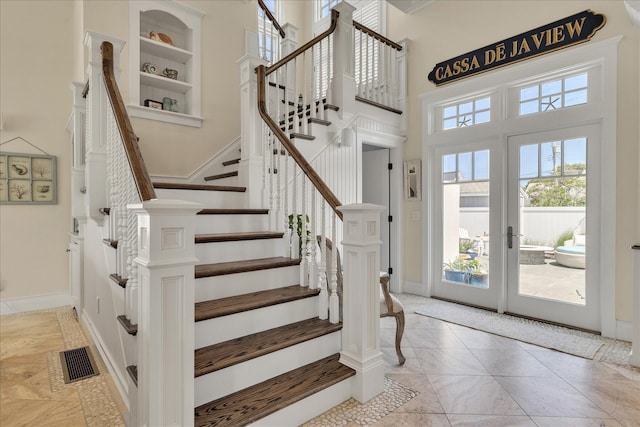 16 Beach View Rd, West Dennis, MA 02670 - entryway featuring a high ceiling, marble finish flooring, stairway, french doors, and baseboards