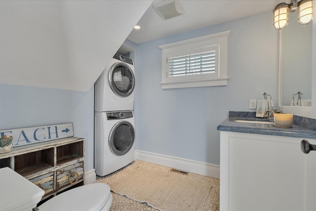 16 Beach View Rd, West Dennis, MA 02670 - bathroom featuring stacked washer and clothes dryer, toilet, vanity, baseboards, and recessed lighting