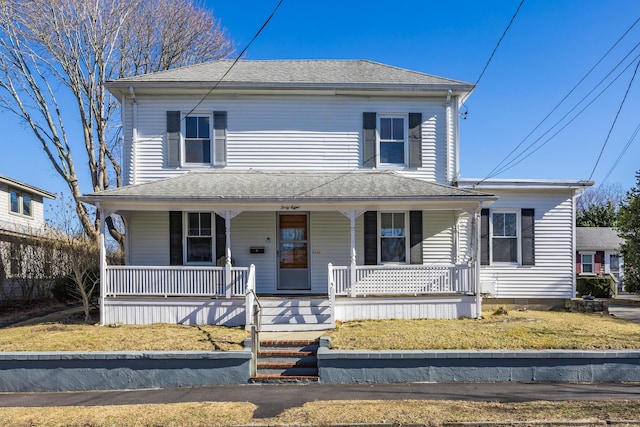 view of front of home featuring covered porch and a shingled roof