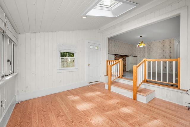 272 Sheep Pond Dr, Brewster, MA 02631 - unfurnished room featuring a skylight, wallpapered walls, stairway, and wood finished floors