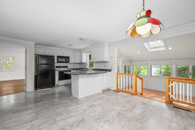 272 Sheep Pond Dr, Brewster, MA 02631 - kitchen with black appliances, a peninsula, healthy amount of natural light, a skylight, and vaulted ceiling