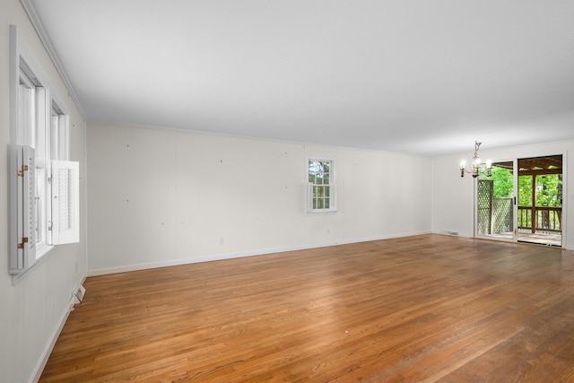 272 Sheep Pond Dr, Brewster, MA 02631 - unfurnished room featuring a chandelier, plenty of natural light, light wood-type flooring, crown molding, and baseboards