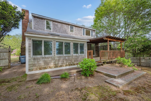 272 Sheep Pond Dr, Brewster, MA 02631 - back of house with a wooden deck, a chimney, and a pergola