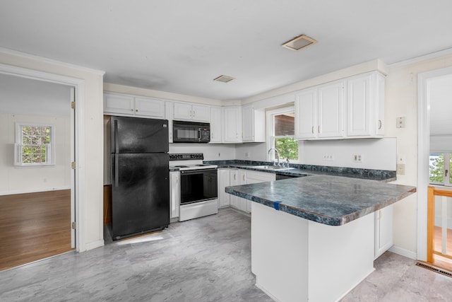 272 Sheep Pond Dr, Brewster, MA 02631 - kitchen with black appliances, a peninsula, dark countertops, white cabinetry, and healthy amount of natural light