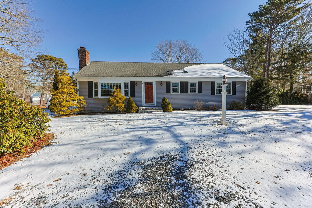 view of front of home featuring a chimney