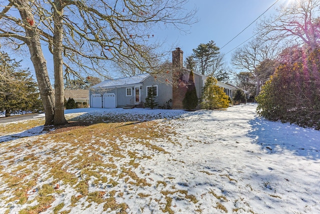 view of front facade with a garage and a chimney