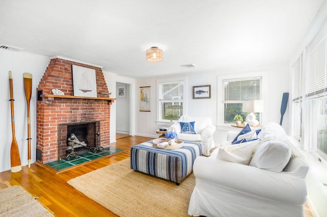429 Paines Creek Rd, Brewster, MA 02631 - living area featuring wood finished floors and a brick fireplace
