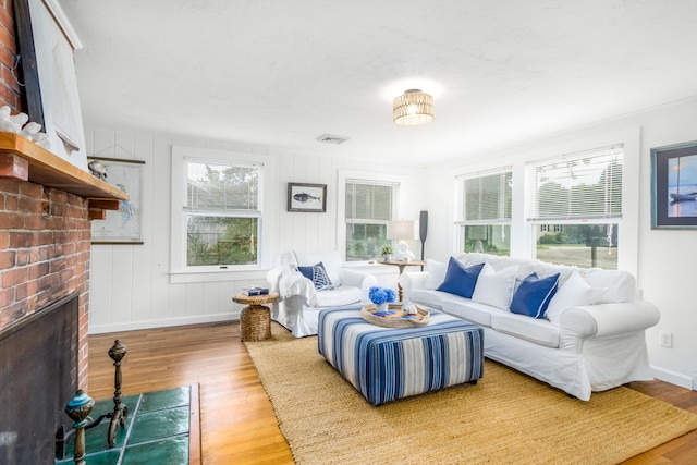 429 Paines Creek Rd, Brewster, MA 02631 - living area featuring a brick fireplace and wood finished floors