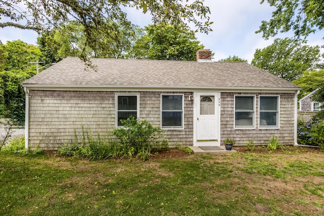 429 Paines Creek Rd, Brewster, MA 02631 - view of front facade featuring a chimney, a front lawn, and roof with shingles