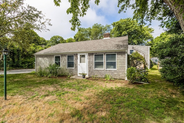 429 Paines Creek Rd, Brewster, MA 02631 - view of front of home featuring a front yard, a chimney, and a shingled roof