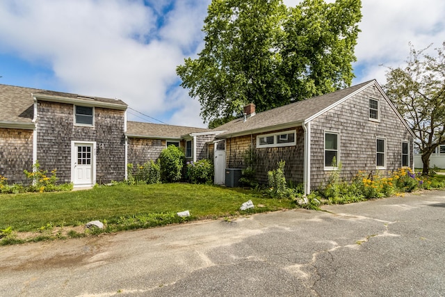 429 Paines Creek Rd, Brewster, MA 02631 - view of home's exterior with a yard, a shingled roof, and a chimney