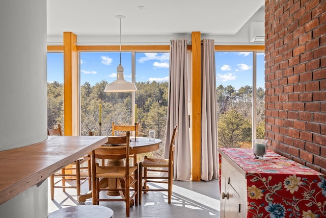 dining space featuring brick wall