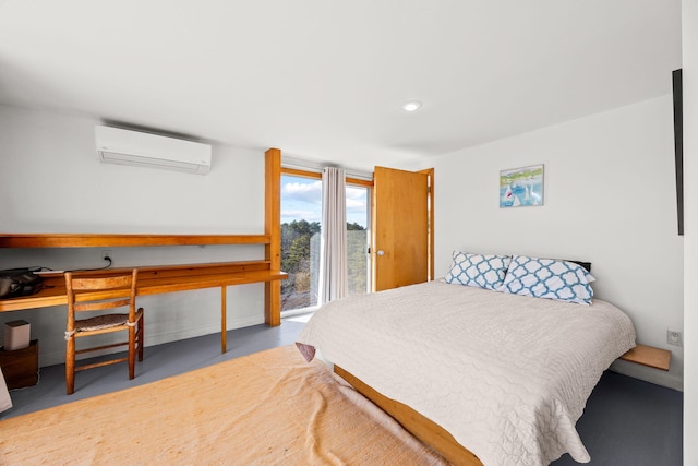 bedroom with concrete flooring and an AC wall unit