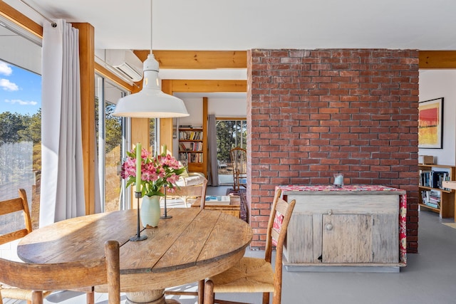 dining room featuring a wall mounted AC and concrete floors