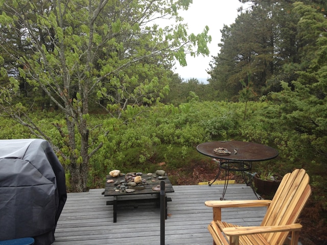 wooden terrace with area for grilling