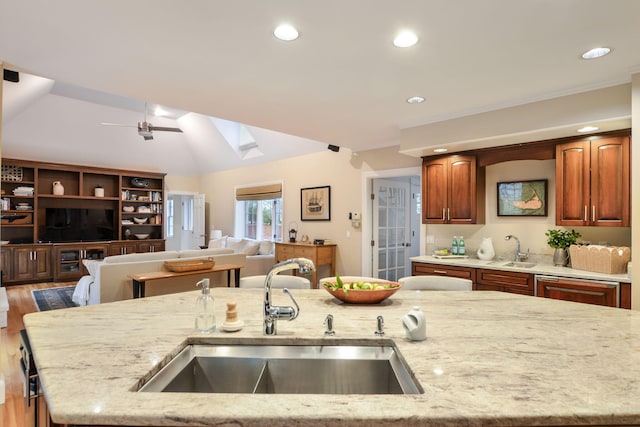 20 Stanley Pl, Hyannis, MA 02601 - kitchen with a sink, open floor plan, a skylight, light stone countertops, and lofted ceiling