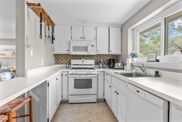 12 Running Light Way, Mashpee, MA 02649 - kitchen with white appliances, backsplash, light countertops, and white cabinets