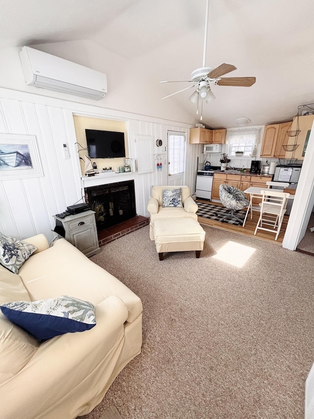 living area with an AC wall unit, ceiling fan, vaulted ceiling, and carpet floors
