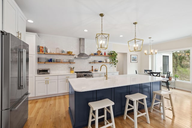 4 Charles Ln, Falmouth, MA 02540 - kitchen featuring stainless steel appliances, wall chimney exhaust hood, a sink, open shelves, and tasteful backsplash