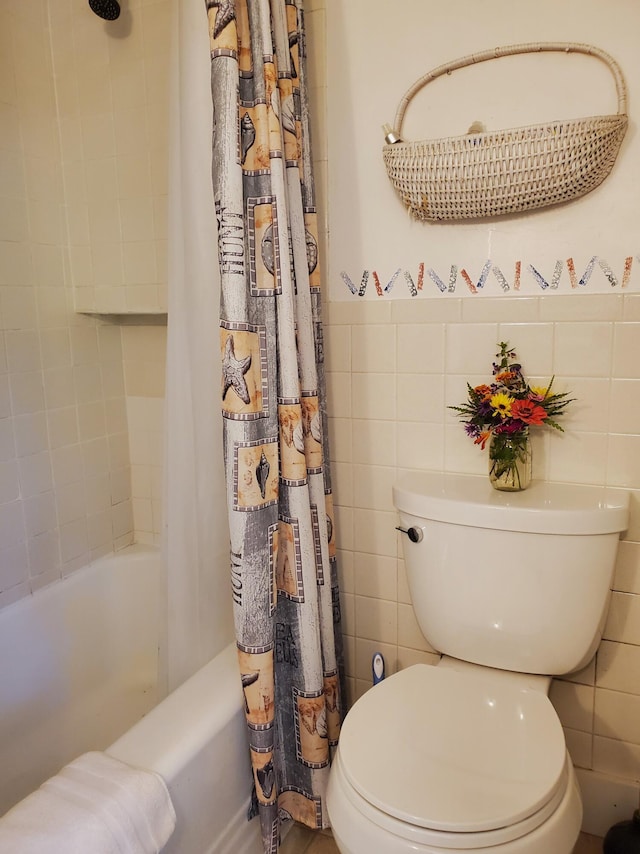 bathroom featuring tile walls, shower / tub combo with curtain, and toilet