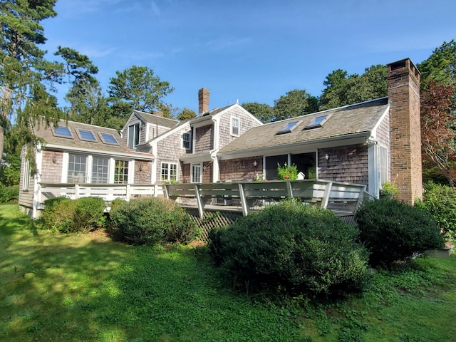 back of house with a yard and a deck