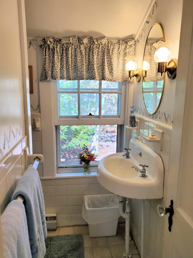 bathroom with tile walls, sink, and tile patterned floors