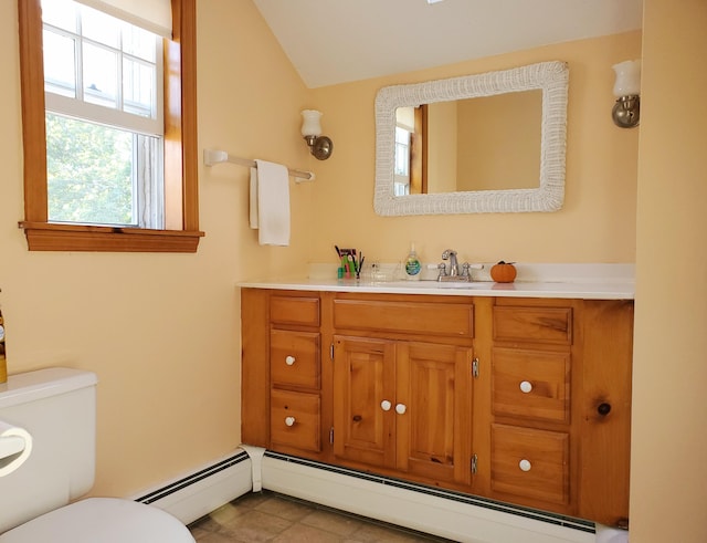 bathroom featuring vanity, lofted ceiling, a baseboard radiator, and toilet