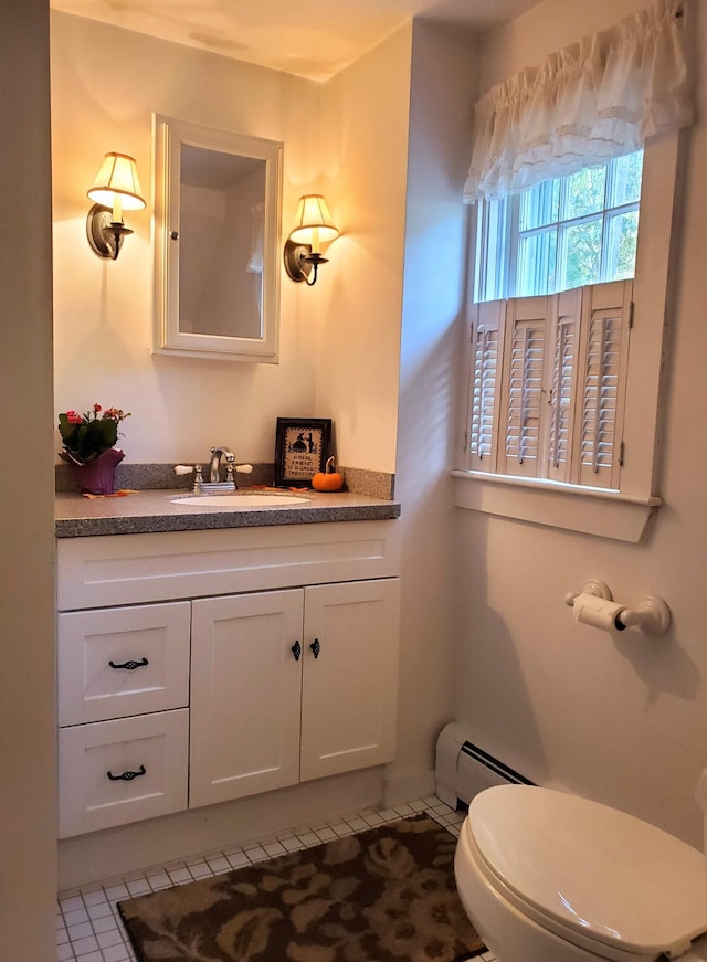 bathroom with vanity, a baseboard radiator, tile patterned floors, and toilet