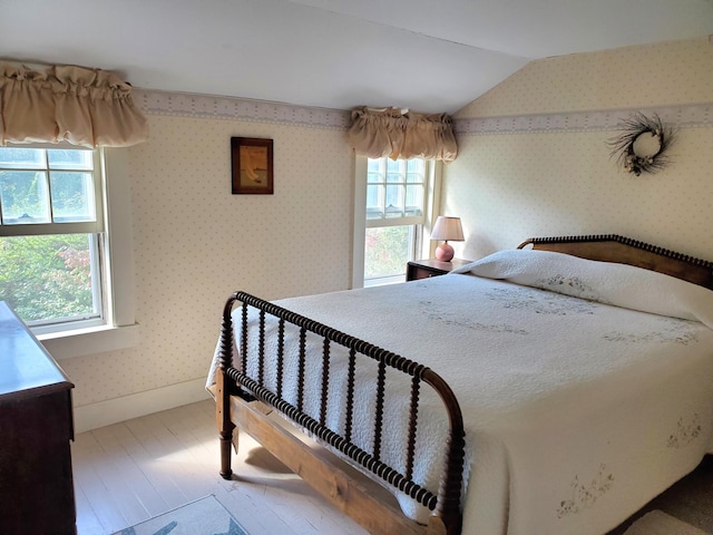 bedroom featuring vaulted ceiling and hardwood / wood-style floors