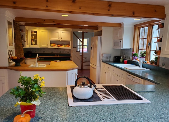 kitchen with white cabinetry, white appliances, sink, and backsplash