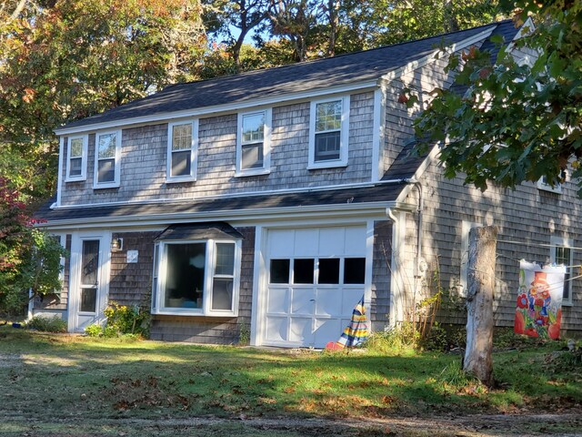 view of front of home with a garage and a front yard