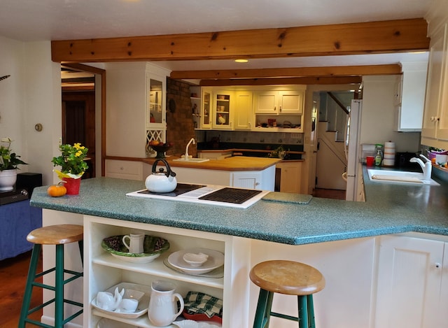 kitchen with white appliances, a kitchen breakfast bar, and sink