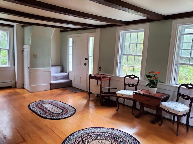 sitting room featuring beam ceiling, light hardwood / wood-style flooring, and a wealth of natural light