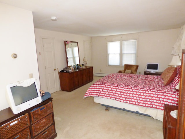 carpeted bedroom featuring baseboard heating