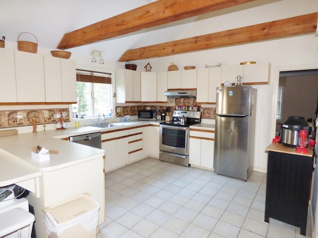 kitchen featuring sink, white cabinetry, lofted ceiling with beams, stainless steel appliances, and decorative backsplash